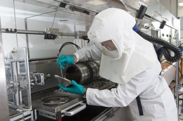 Opérateur avec équipements de protection individuelle dans un laboratoire où sont manipulés des nanomatériaux